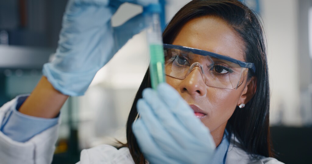 Portrait Of Dark Skin Female Scientist Is Analyzing A Liquid To