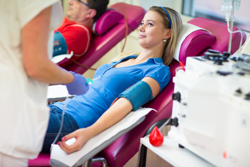 Young Woman Giving Blood In A Modern Hospital (color Toned Image)